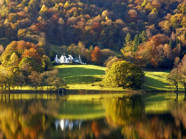 Grasmere lake with autumn colours and reflections, Lake District, Cumbria, England